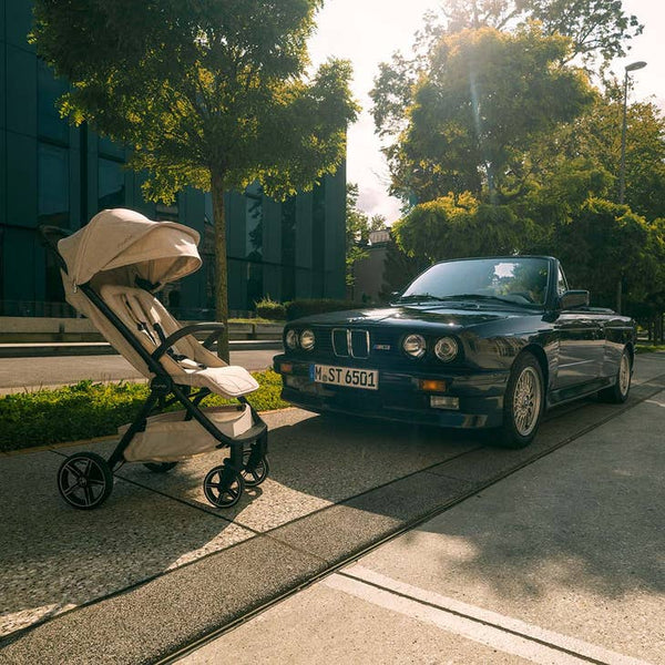 Nuna TRVL lx Compact Stroller with Travel Bag - Mica ( Delicate Neutral Beige BMW Logo)